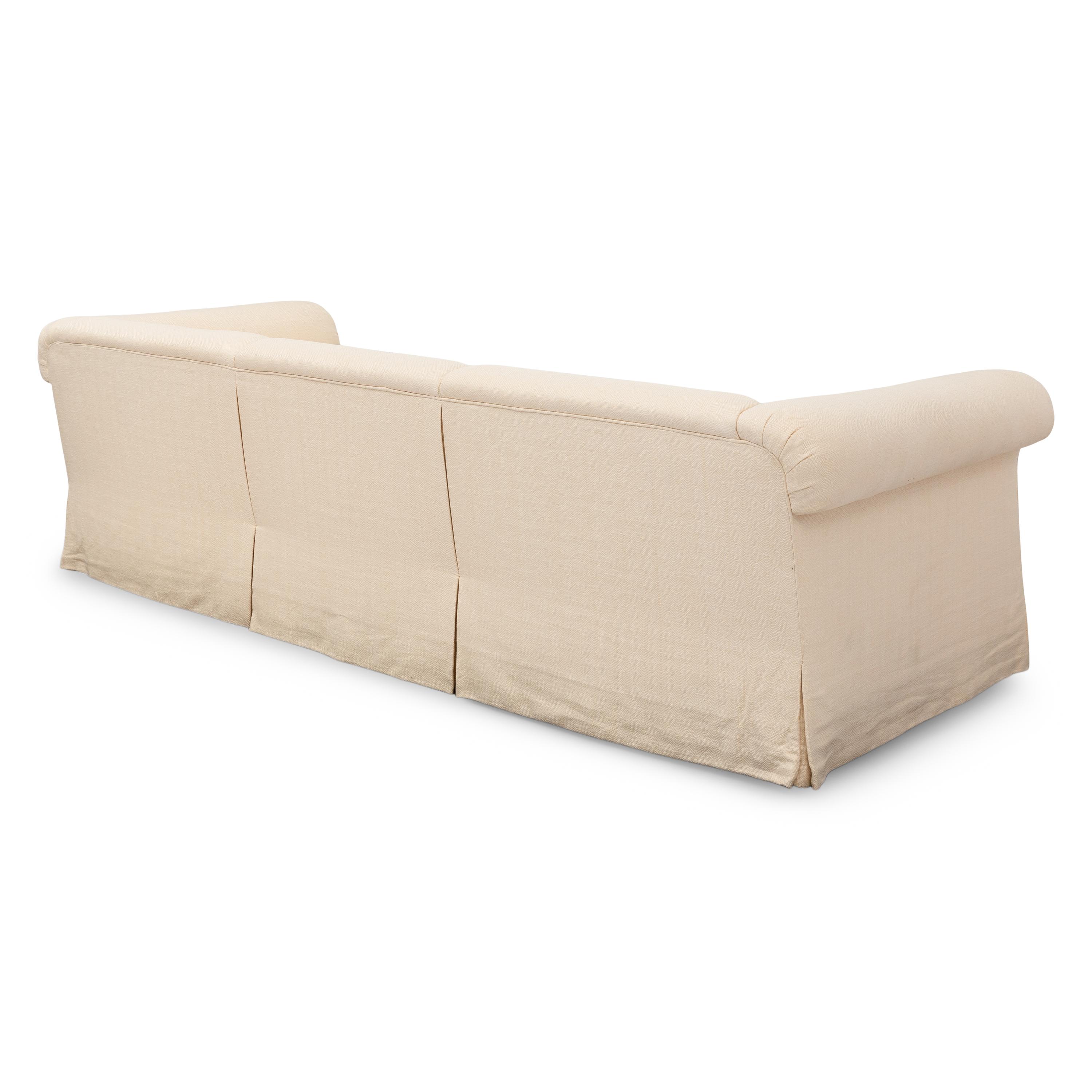 A Cream-Twill Upholstered Three-Cushion Sofa