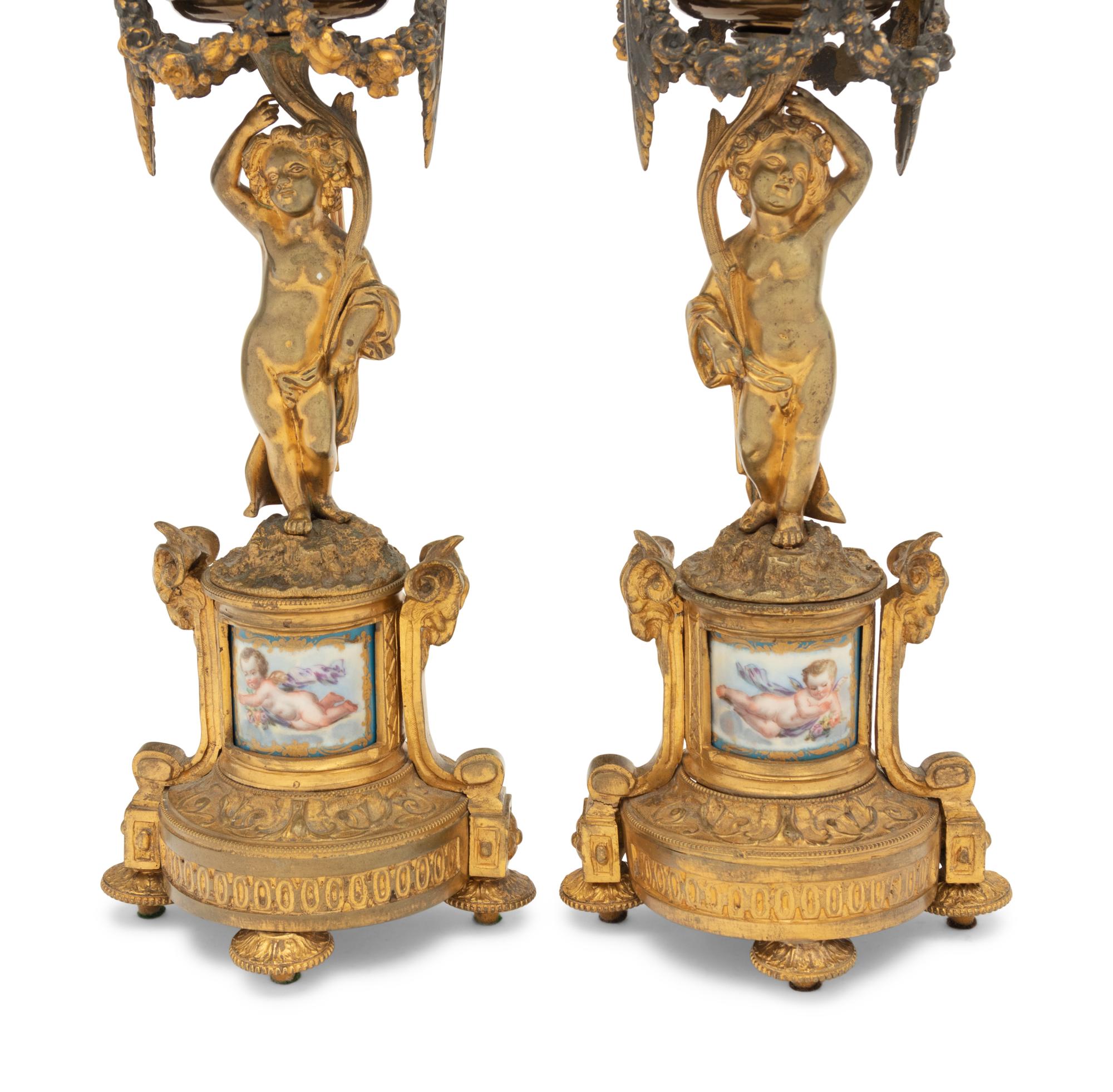 A Pair of French Porcelain Mounted Gilt Bronze Figural Lamps