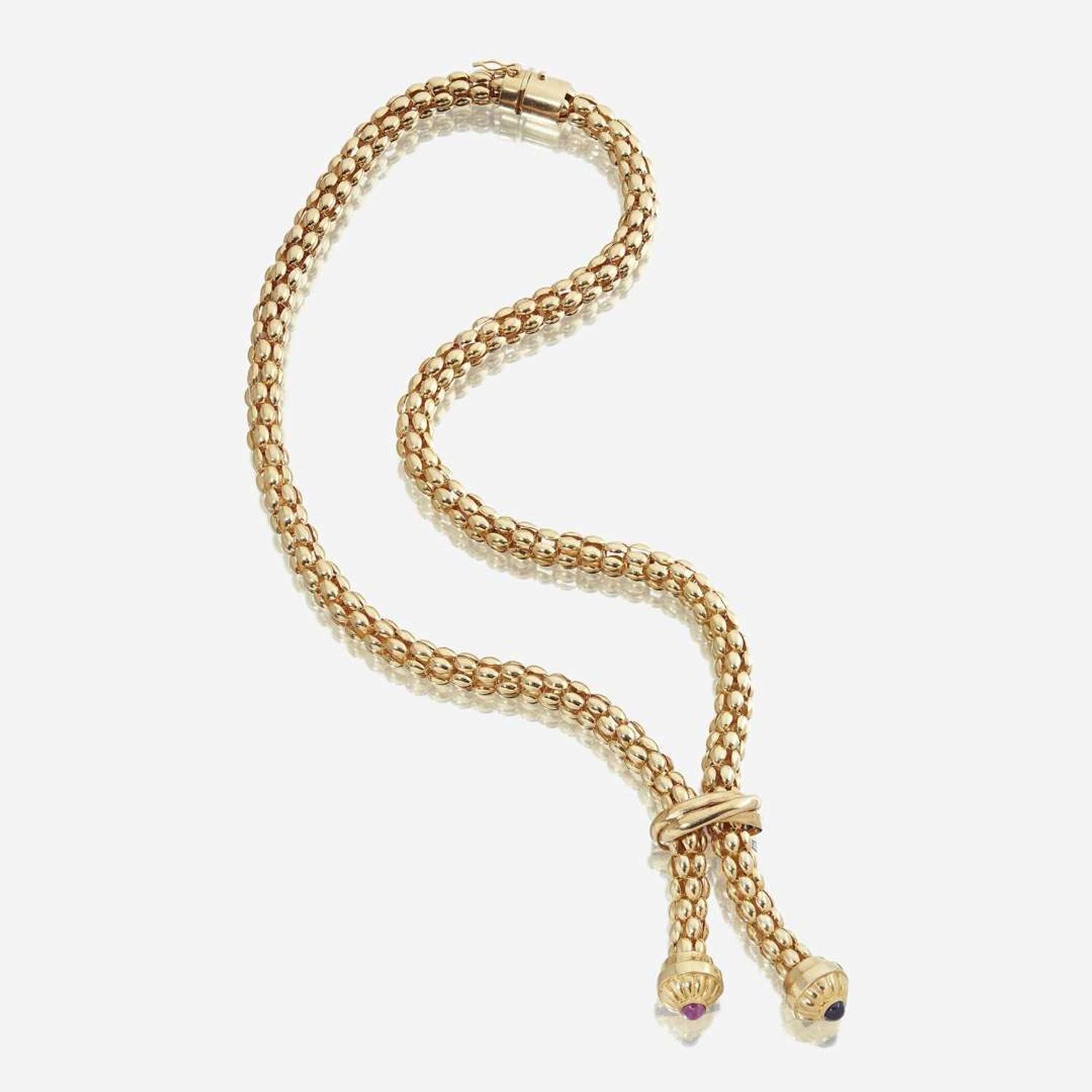 An eighteen karat gold, sapphire, ruby, and diamond lariat