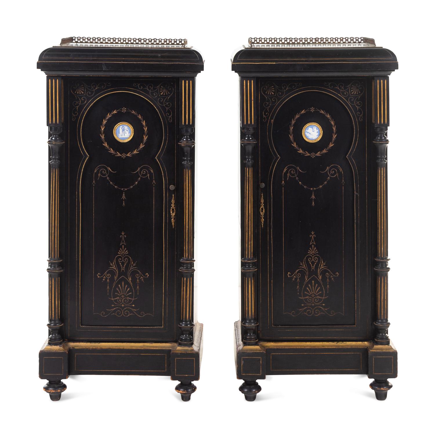 A Pair of English Aesthetic Jasperware Medallion-Mounted Ebonized and Parcel-Gilt Pedestal Cabinets