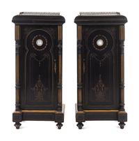 A Pair of English Aesthetic Jasperware Medallion-Mounted Ebonized and Parcel-Gilt Pedestal Cabinets
