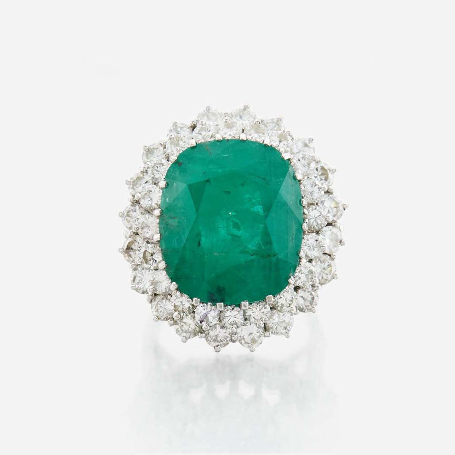 An emerald, diamond and white gold ring