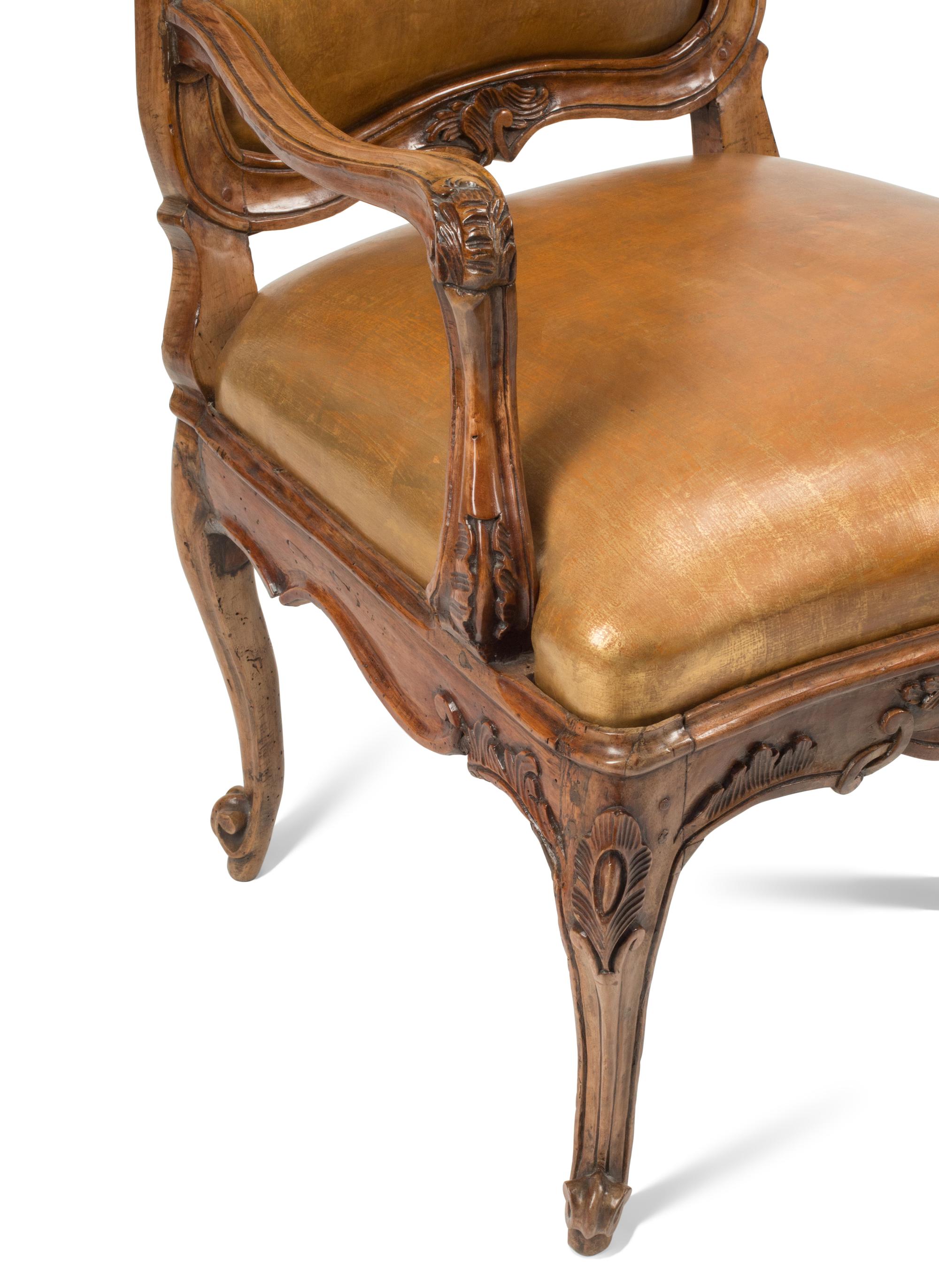A Pair of French Provincial Carved Walnut Armchairs