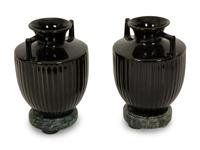 A Pair of Black Porcelain Urns on Green Marbelized Bases