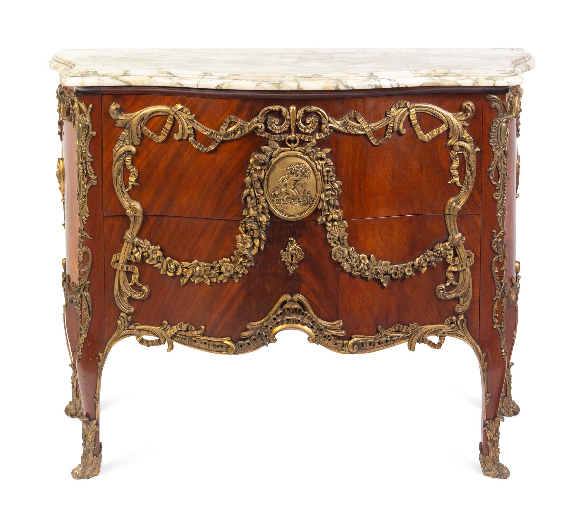 A Louis XV Style Gilt Metal Mounted Figured Walnut Commode