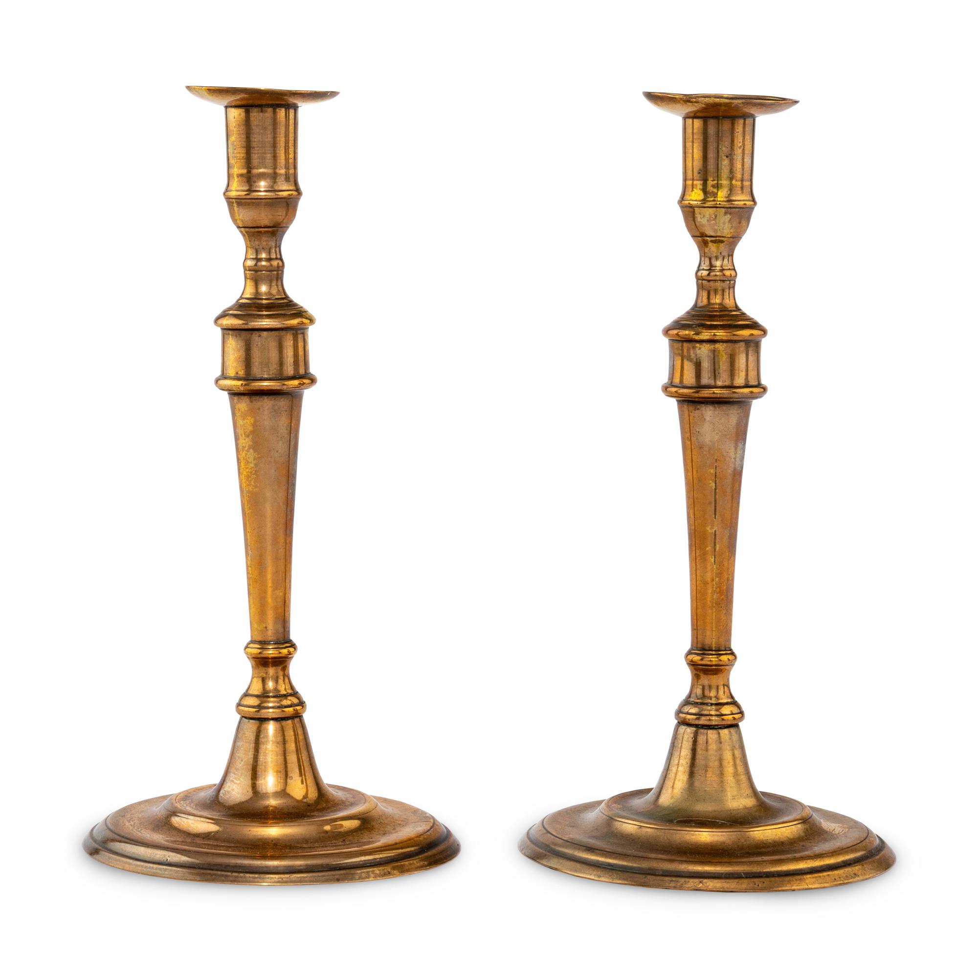 A Pair of George III Bell Metal Candlesticks