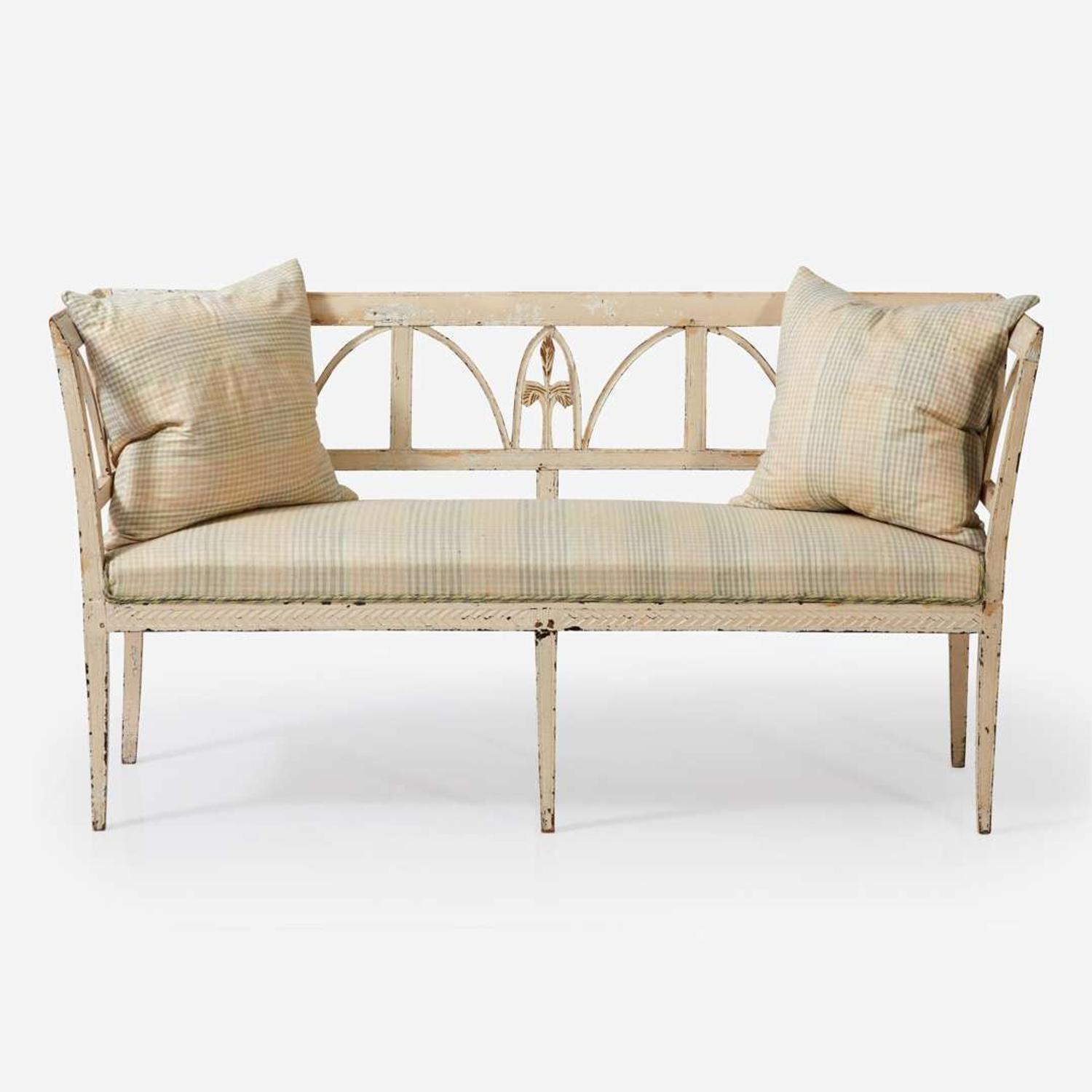 A Northern European cream-painted carved wood settee late 19th / early 20th century