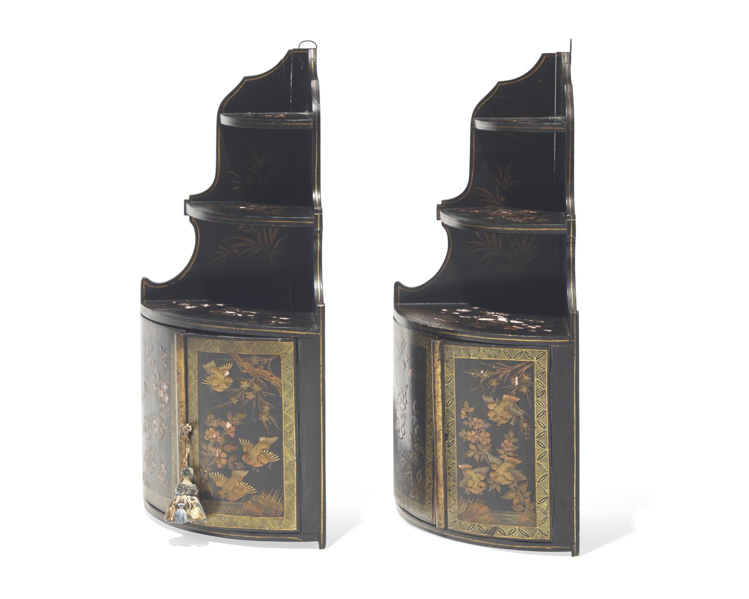 A pair of diminutive Regency style japanned hanging corner cupboards, 19th century