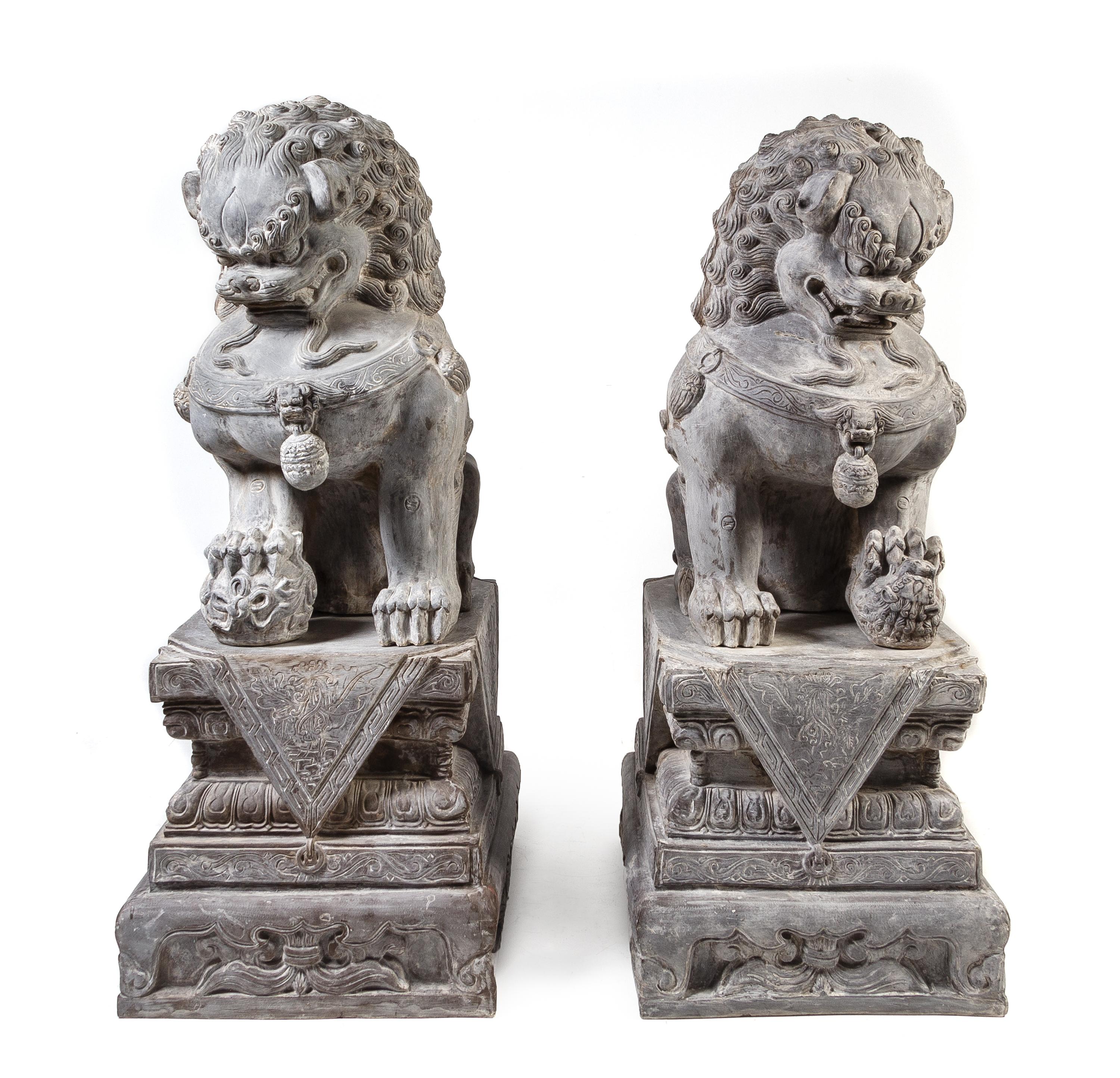 A Pair of Large Composition Temple Guardians Height overall 66 inches. — 20TH CENTURY