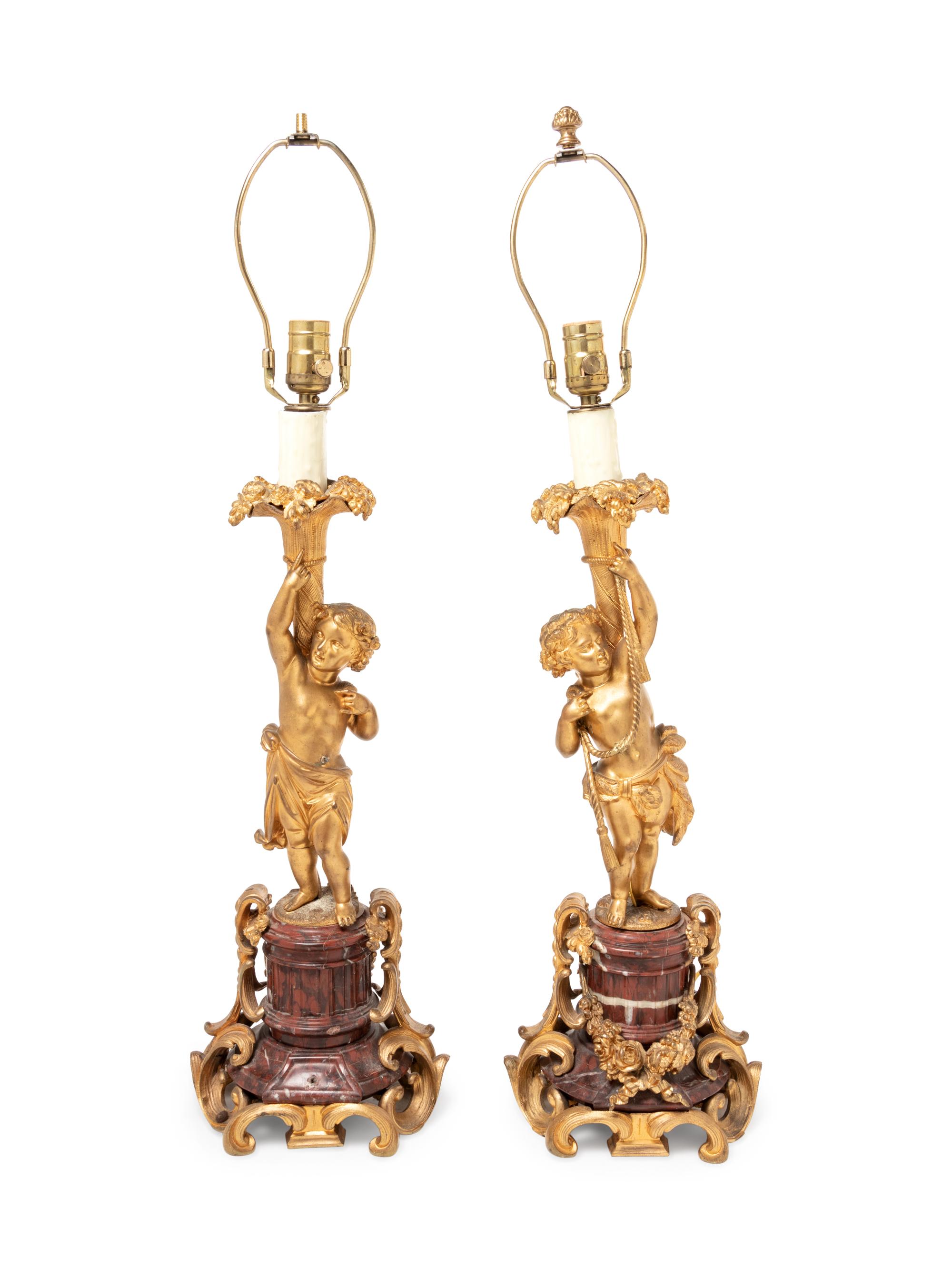 A Pair of Louis XV Style Gilt Bronze Figural Candlesticks