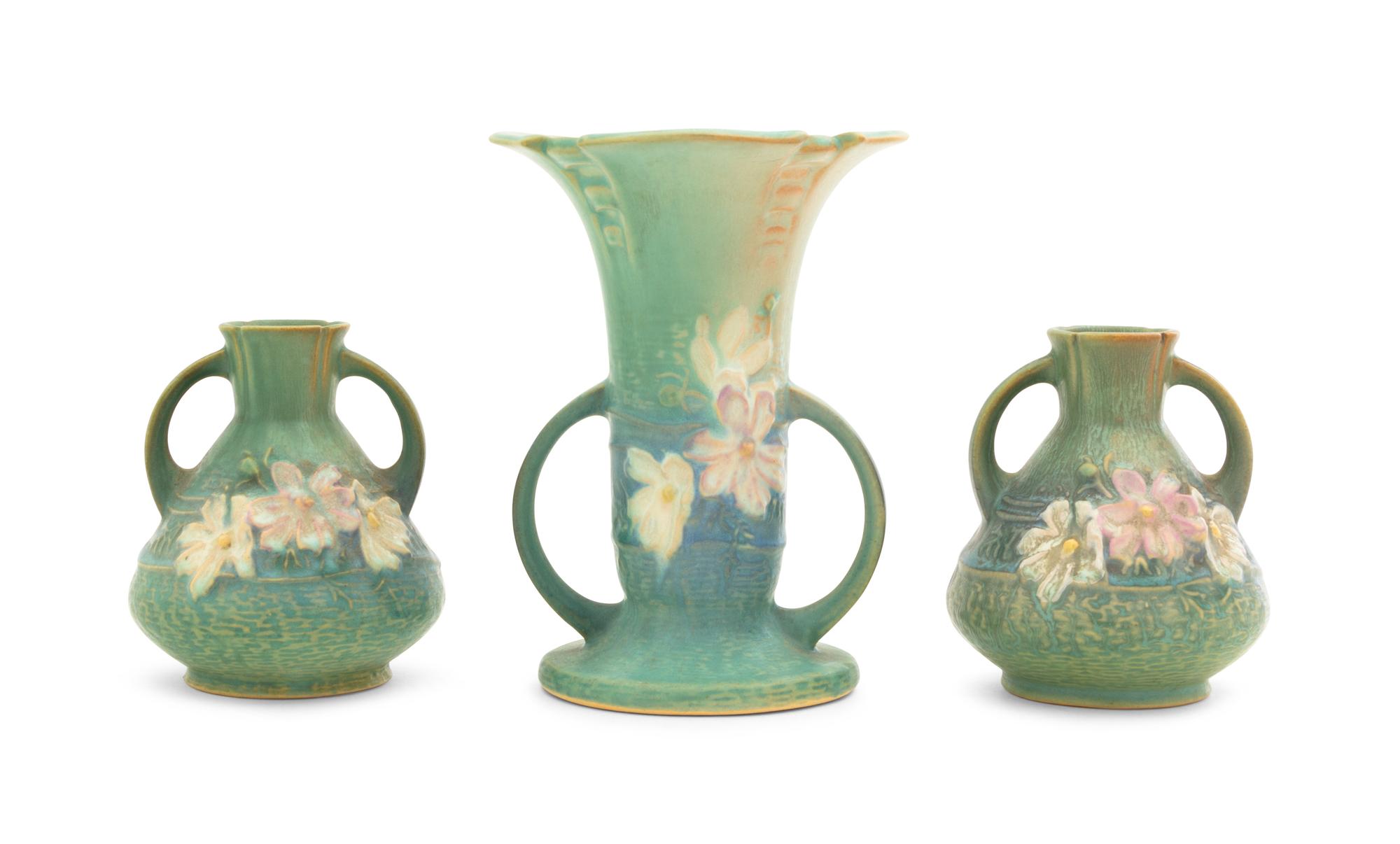 Three Roseville Cosmos Pottery Vases Height of first 6 1/4 inches, pair 4 1/4 inches.
