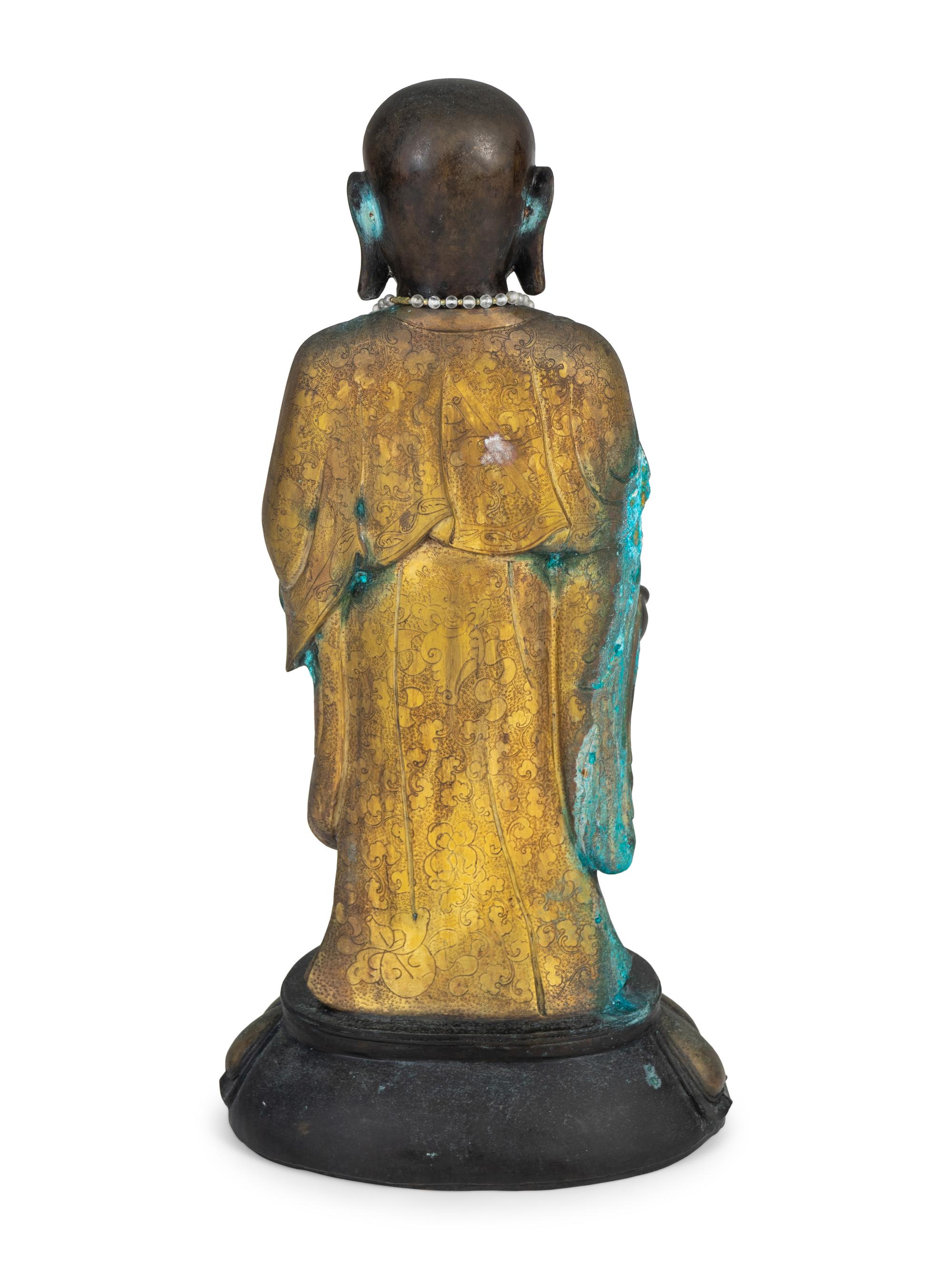 A Chinese Parcel-Gilt and Patinated Bronze Figure — 20TH CENTURY