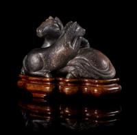 A Brown and Black Jade Figural Group of Two Horses Length 7 1/2 inches.
