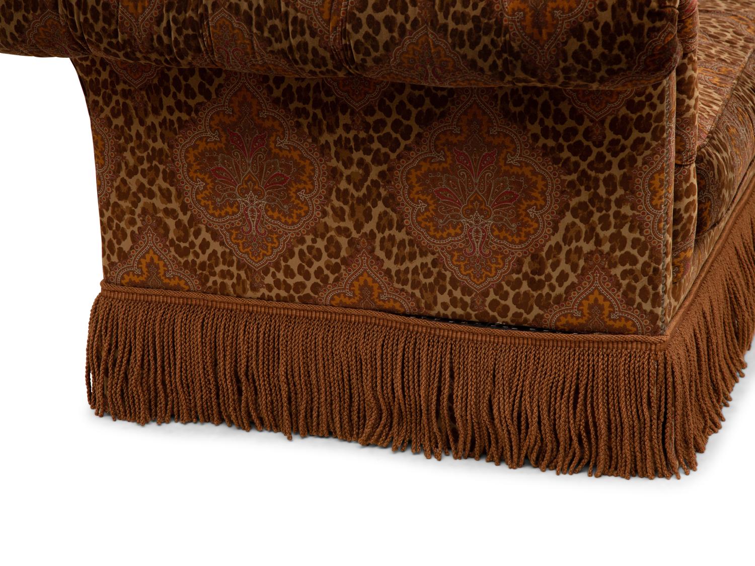A Chesterfield Style Velvet-Upholstered Sofa with a Fringed Skirt