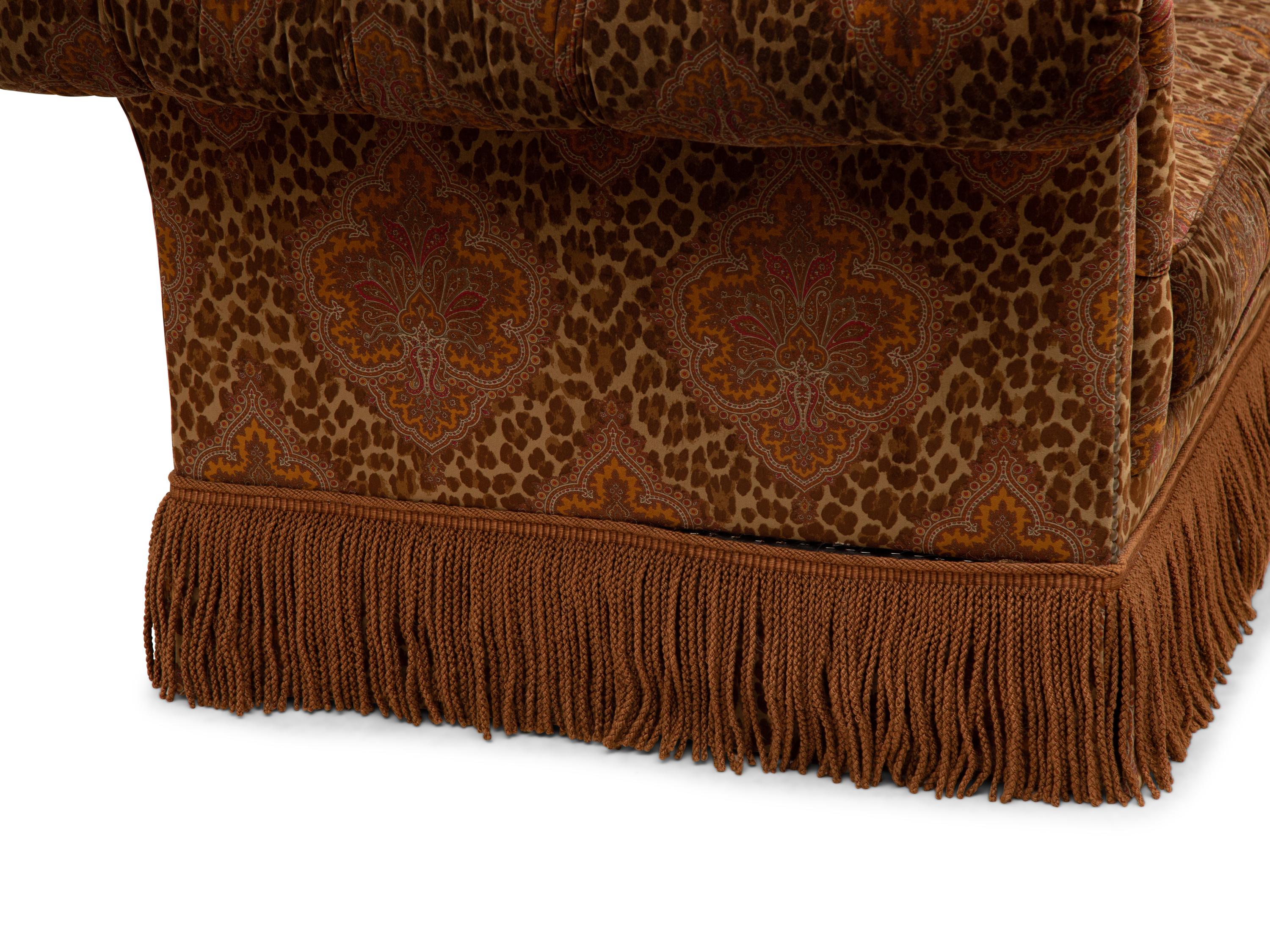 A Chesterfield Style Velvet-Upholstered Sofa with a Fringed Skirt