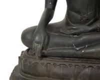 A Cambodian Bronze Figure of Seated Deity on Conforming Base