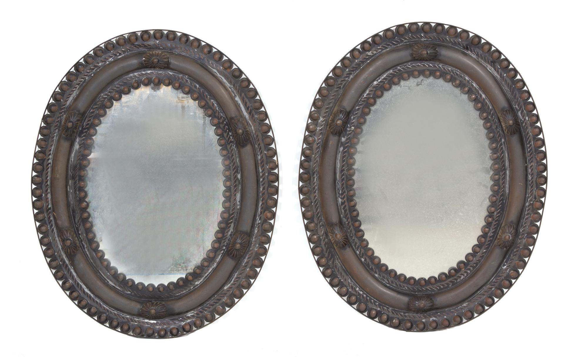 A Pair of Stamped Metal Oval Mirrors 30 1/2 x 24 inches. — EARLY 20TH CENTURY