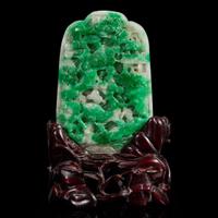 A Chinese carved jadeite panel and wood stand