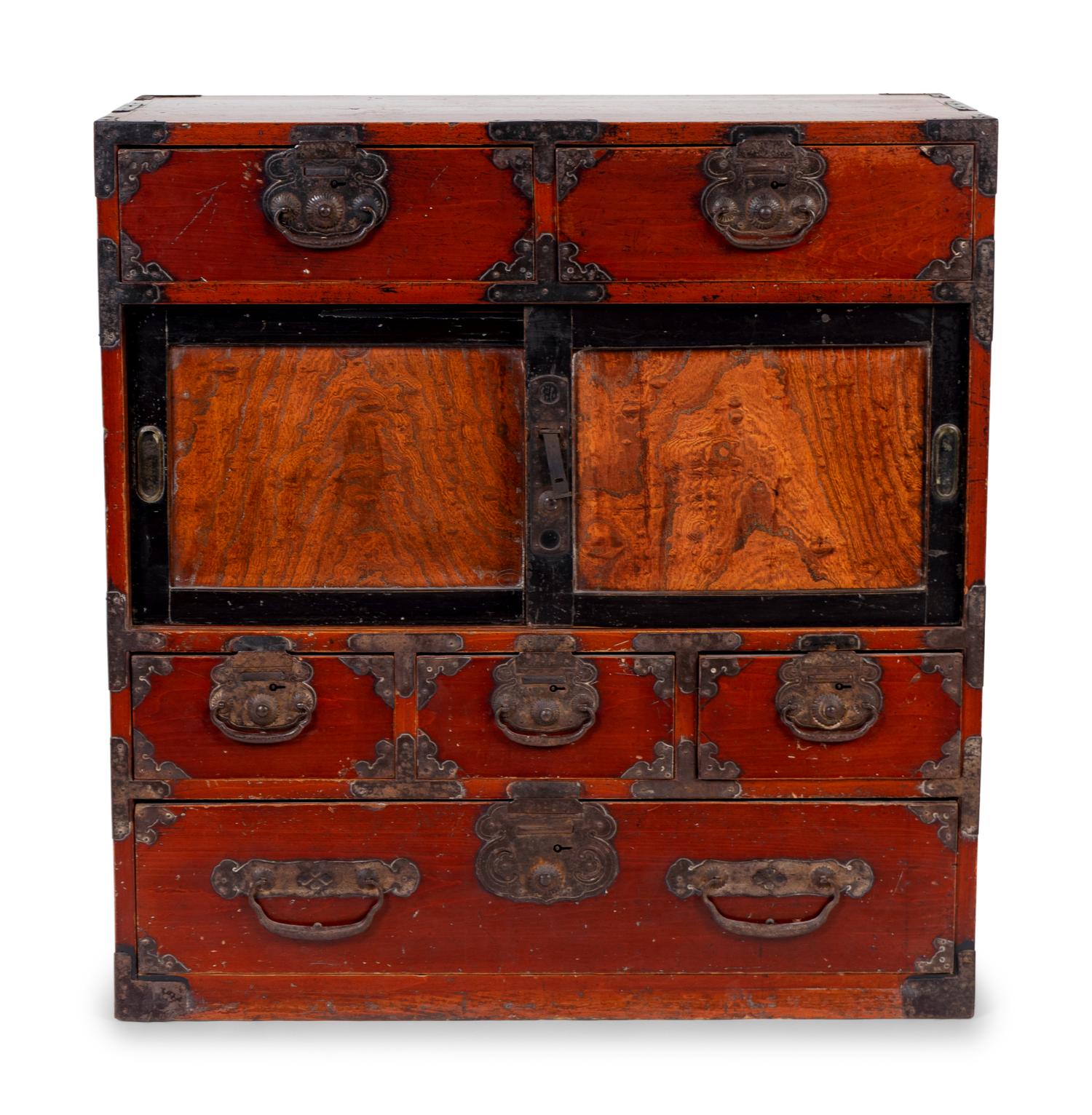 A Japanese Iron Mounted Red Stained Wood Tansu — 20TH CENTURY