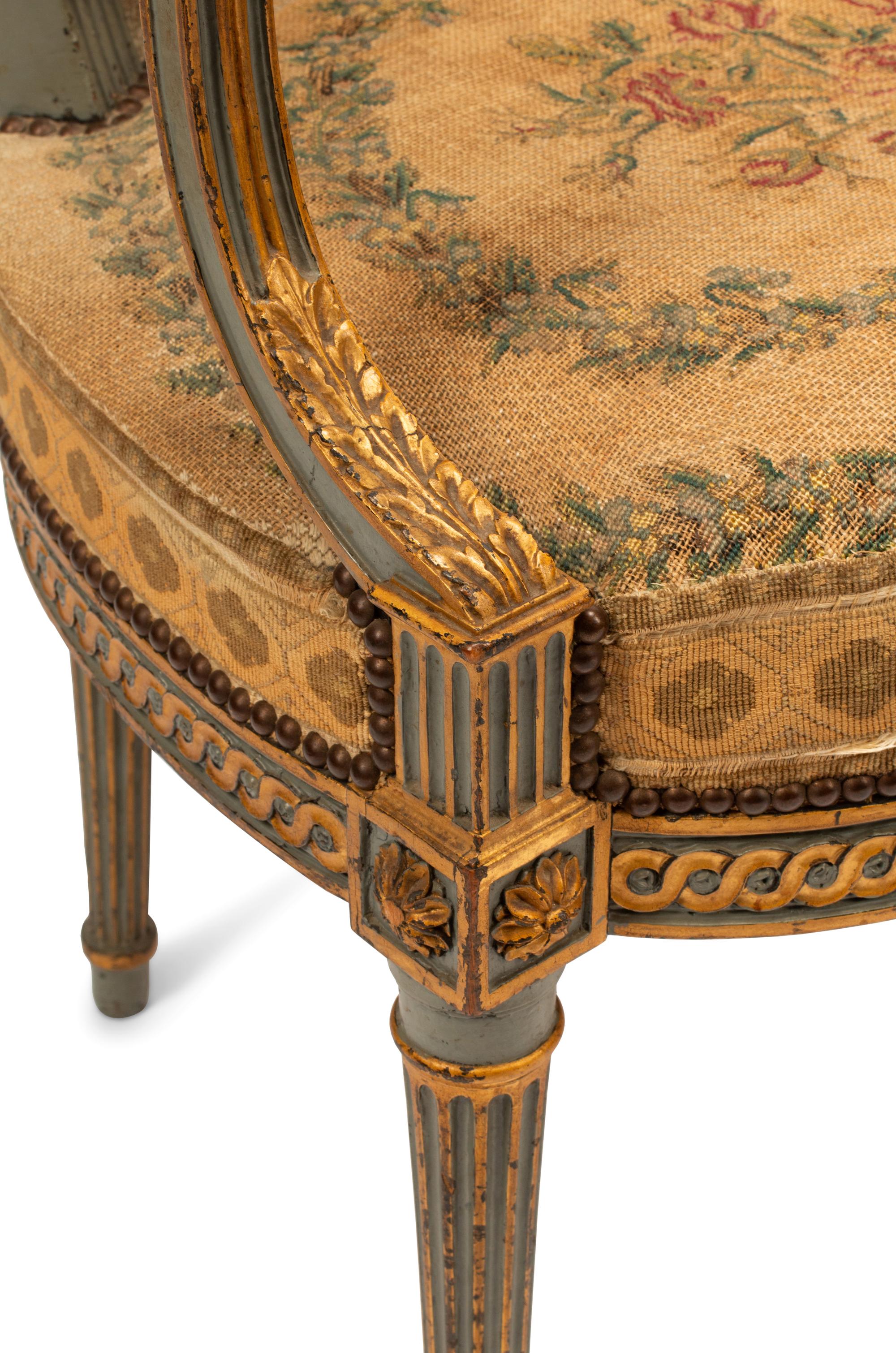 A Pair of French Neoclassical Painted and Parcel Gilt Armchairs