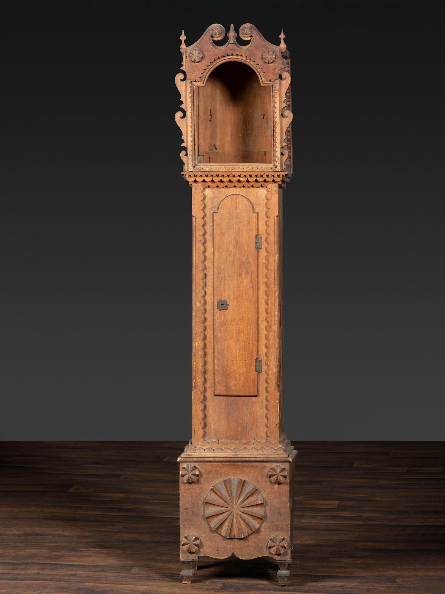 A Folk Art Carved Maple Clock Case
