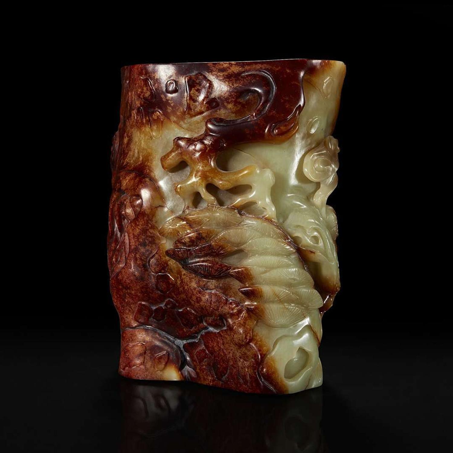 A Chinese carved russet and celadon jade brush holder 青玉笔筒
