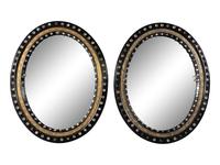 A Pair of Irish Ebonized and Parcel-Gilt Oval Mirrors