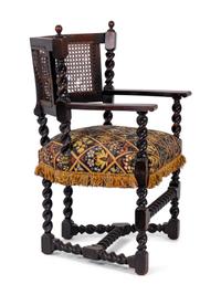 A Jacobean Style Carved Oak Cane Back Armchair — 19TH/20TH CENTURY