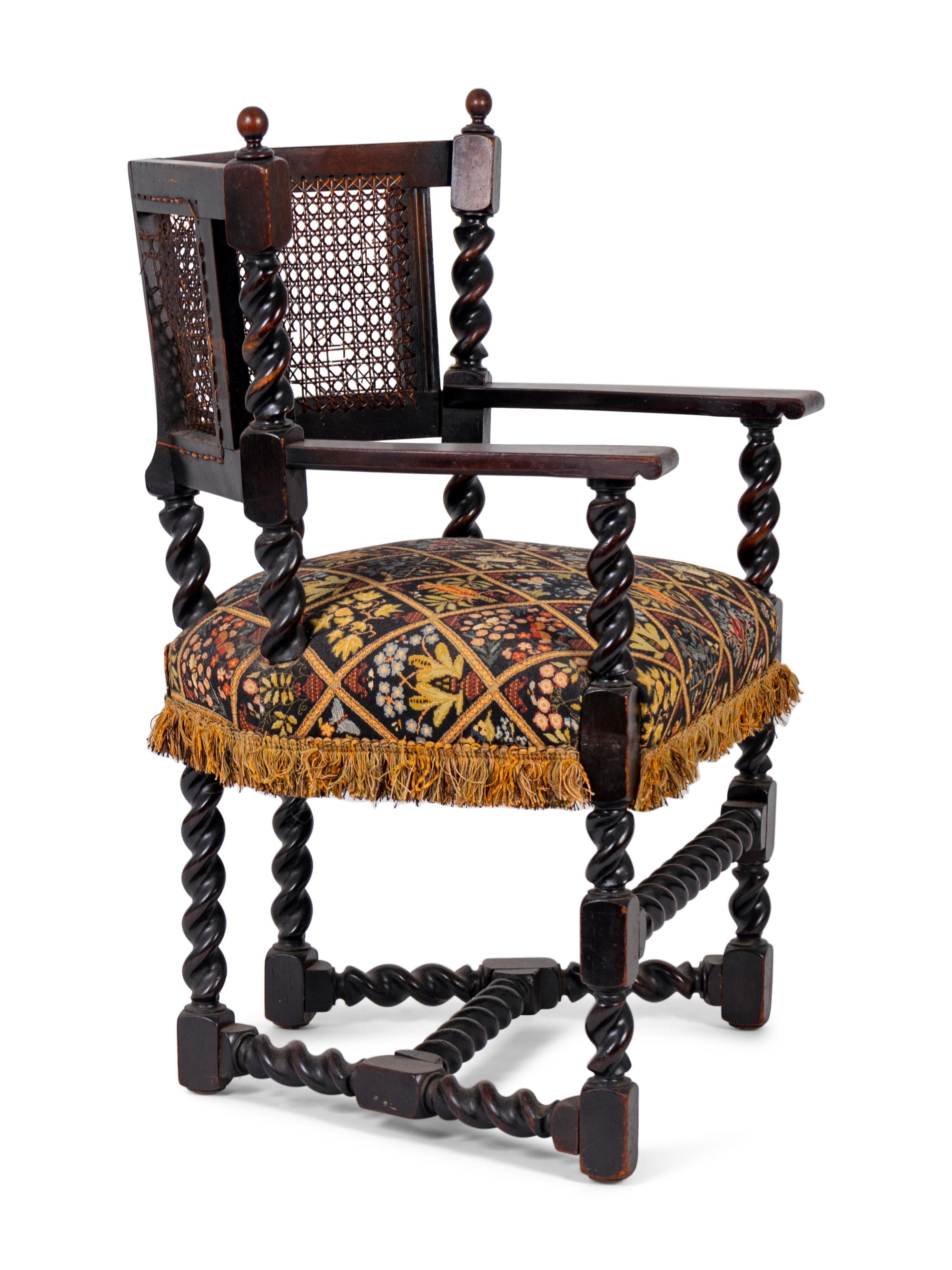 A Jacobean Style Carved Oak Cane Back Armchair — 19TH/20TH CENTURY