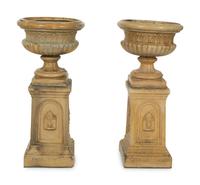 A Pair of Continental Ceramic Urns on Pedestals — EARLY 20TH CENTURY