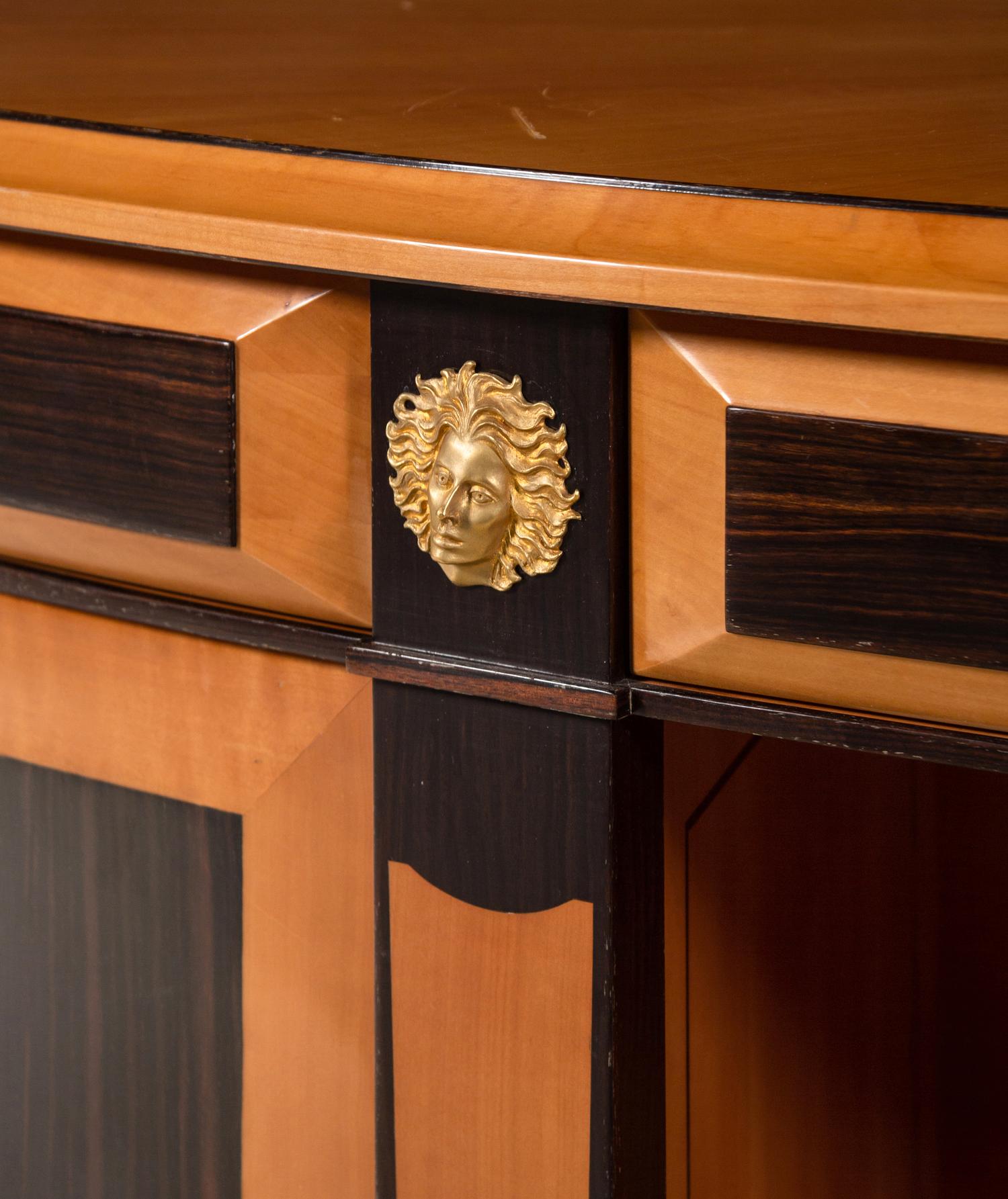 A Custom Gilt Bronze Mounted Part-Ebonized Satinwood Demilune Cabinet