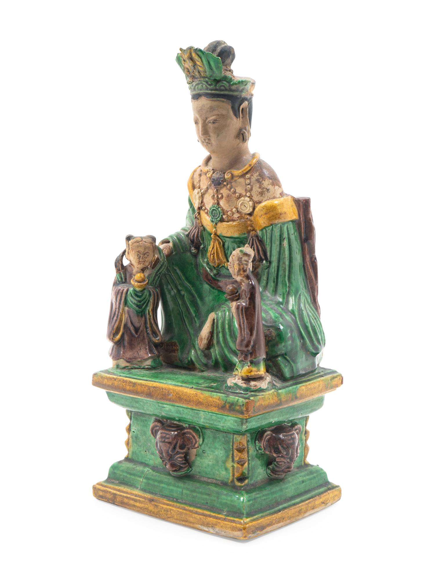 A Chinese Sancai Glazed Stoneware Figure of Seated Guanyin — MING DYNASTY (1368-1644)