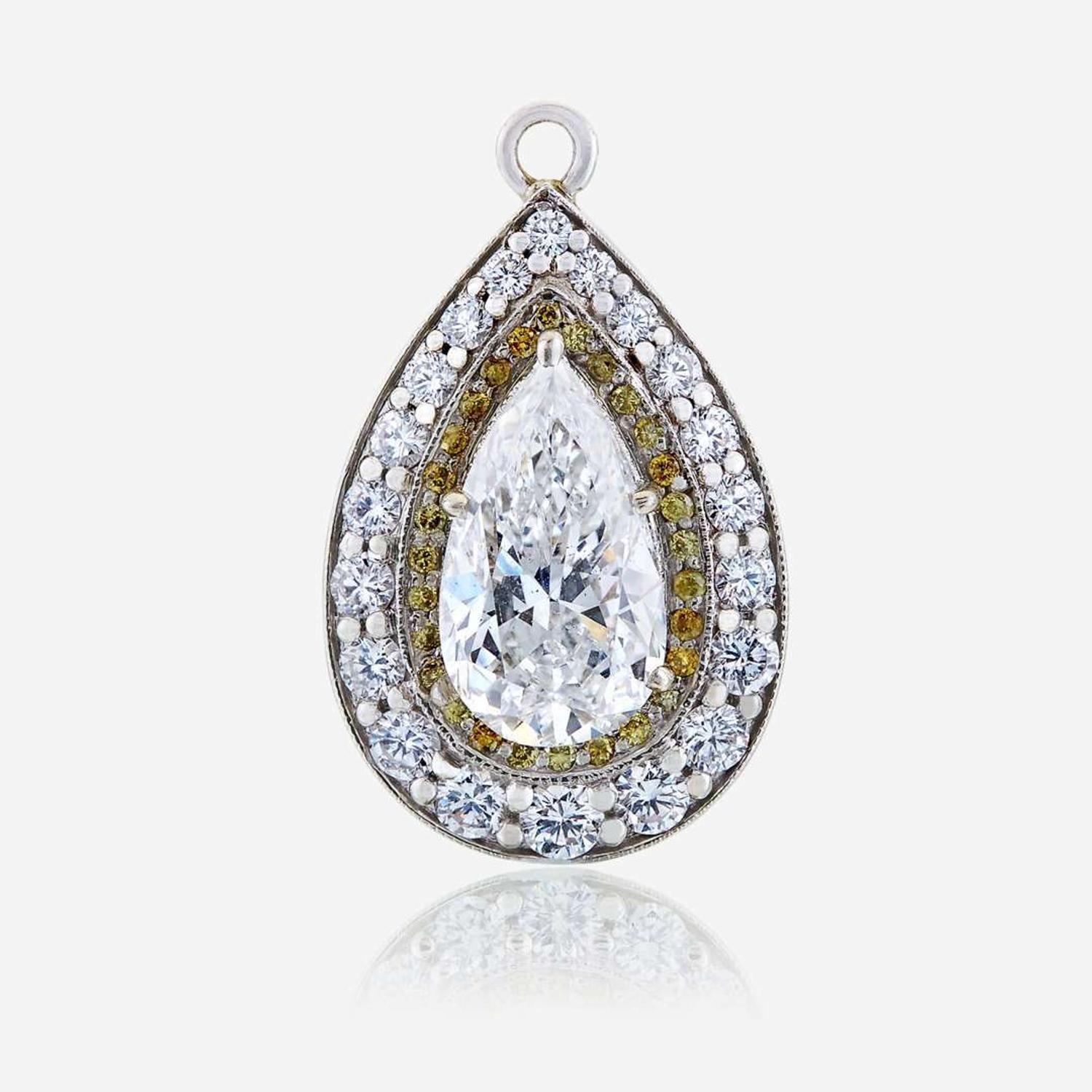 A diamond, colored diamond, and ten karat white gold pendant