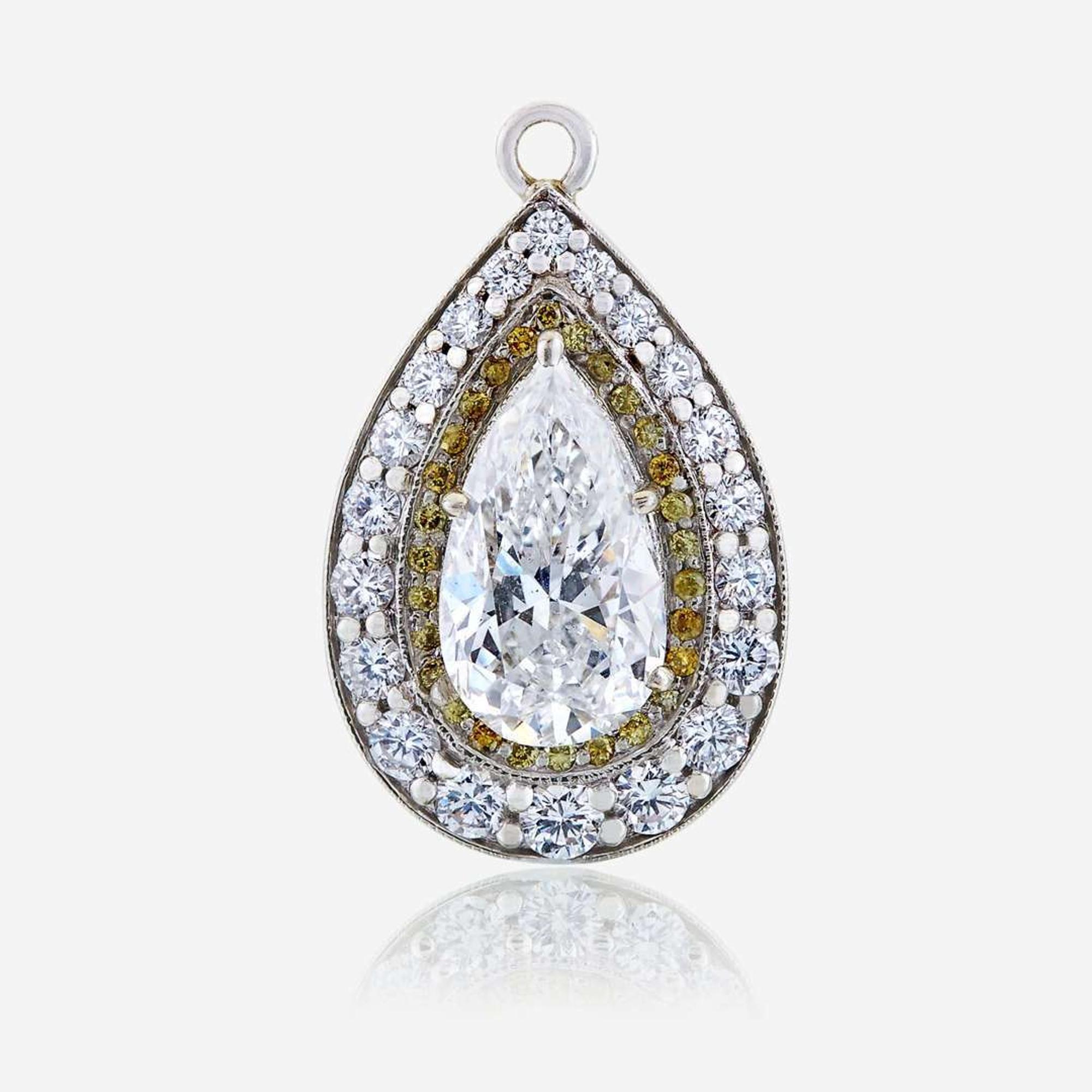 A diamond, colored diamond, and ten karat white gold pendant