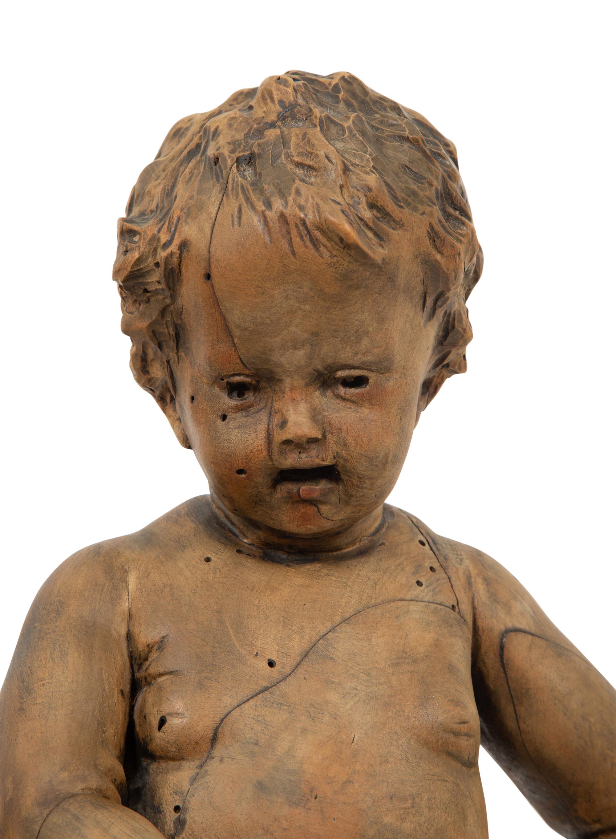 A Flemish Carved Wood Putto