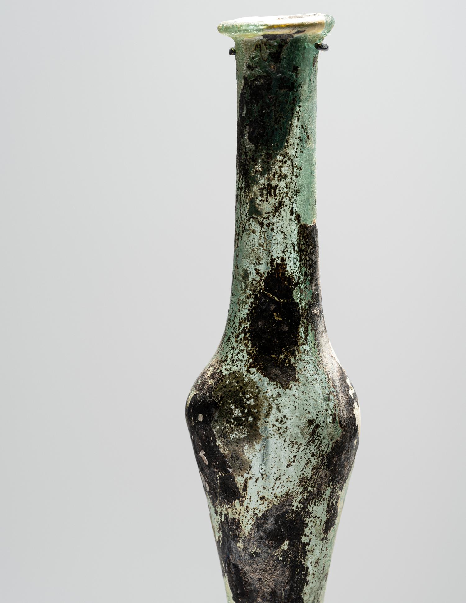 A Roman Pale Blue Glass Unguentarium