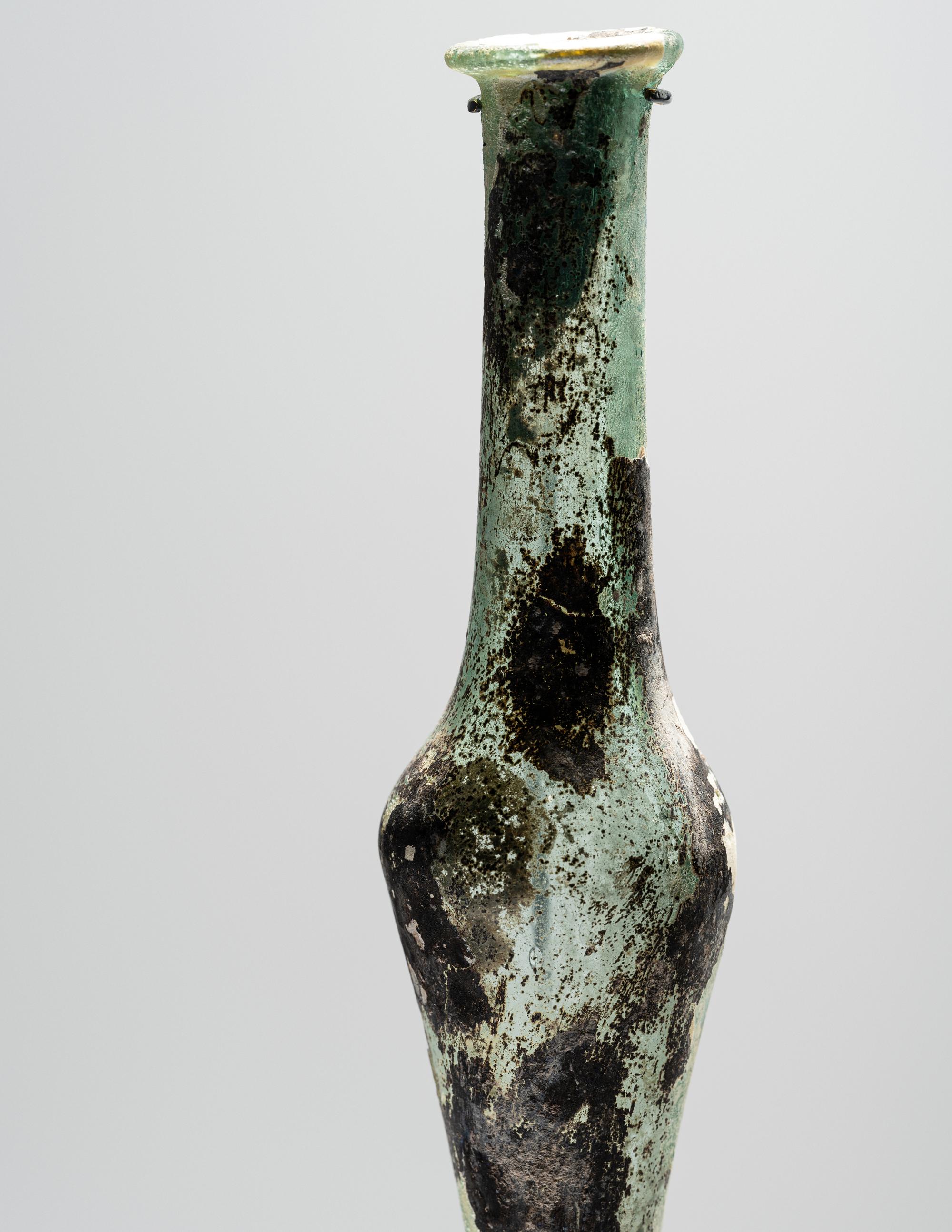 A Roman Pale Blue Glass Unguentarium