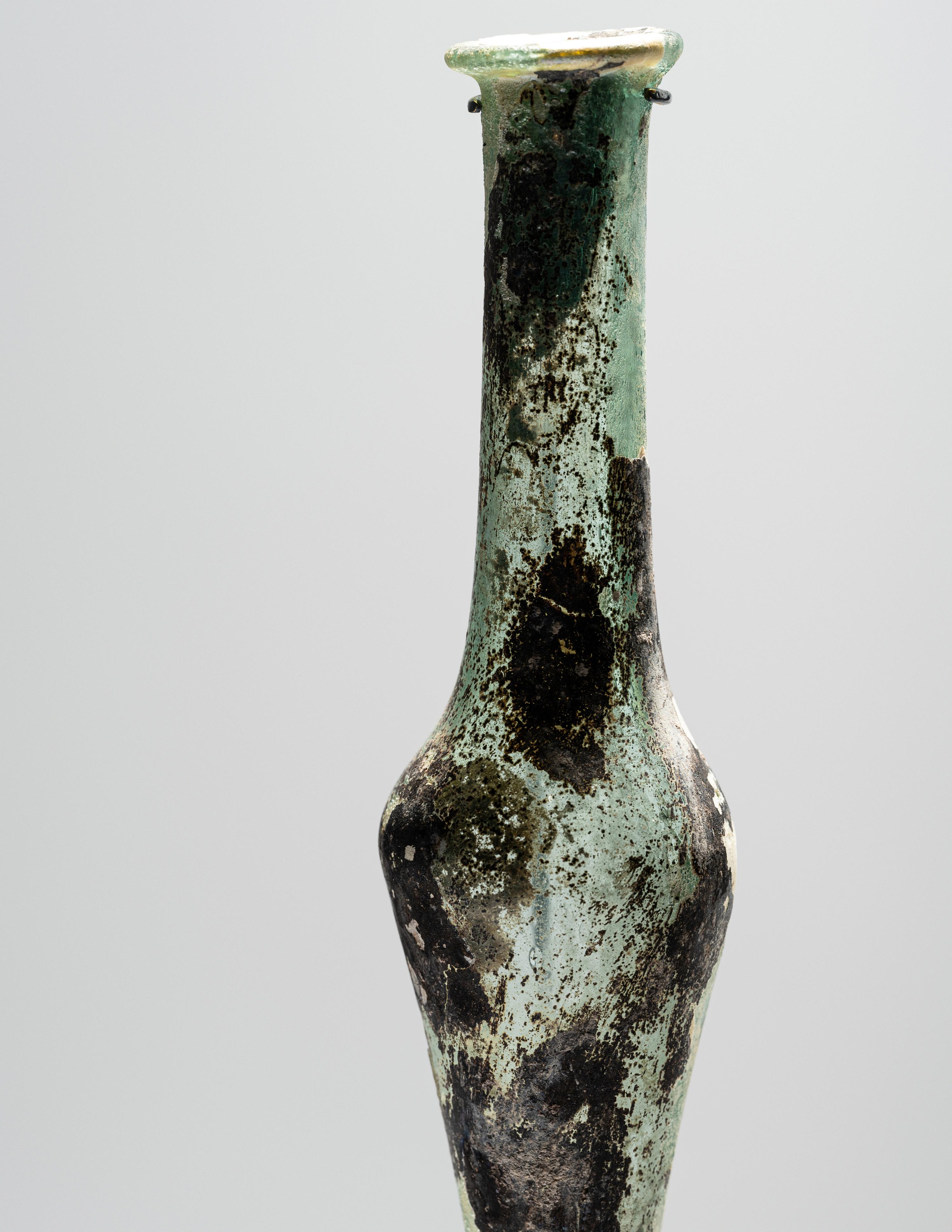 A Roman Pale Blue Glass Unguentarium