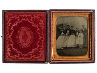 [EARLY PHOTOGRAPHY]. Tintype featuring a group of women standing outside of a Civil War photographer's tent, possibly at Camp Parole, Annapolis, MD.