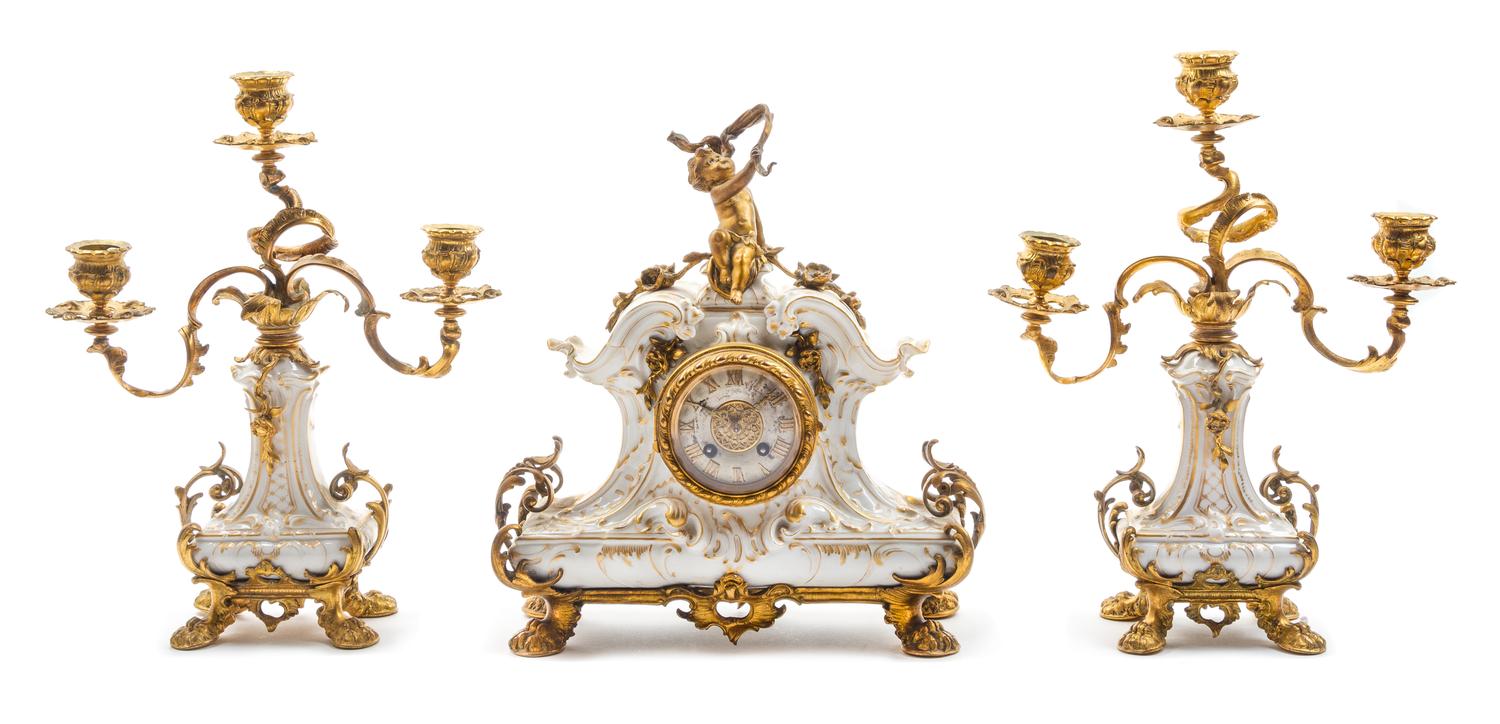 A Berlin (K.P.M.) Porcelain and Gilt Bronze Clock Garniture Height of candelabra 13 inches. — 19TH CENTURY
