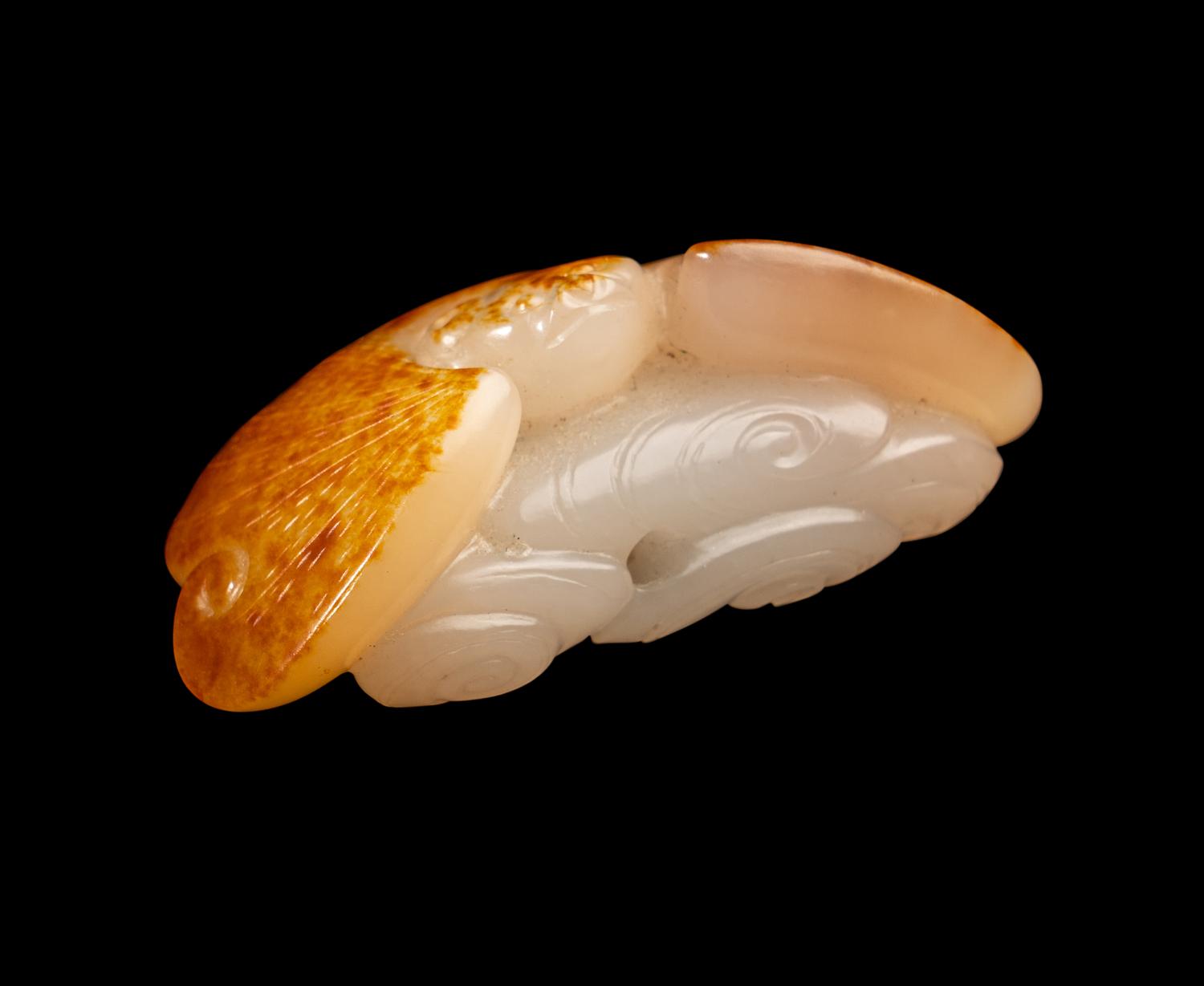 A Chinese Russet and White Jade Figure of a Bat