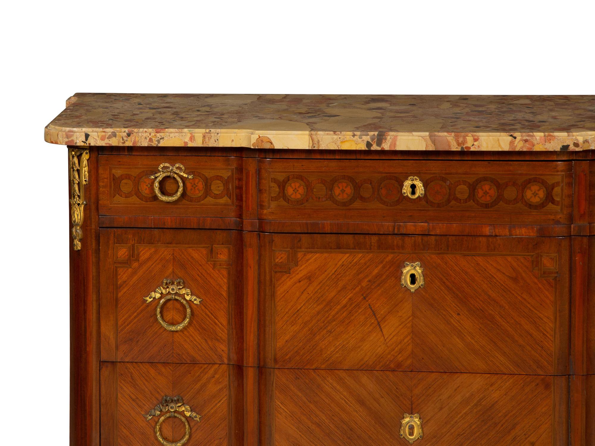 A French Gilt Metal Mounted Mahogany and Kingwood Marquetry Marble-Top Commode