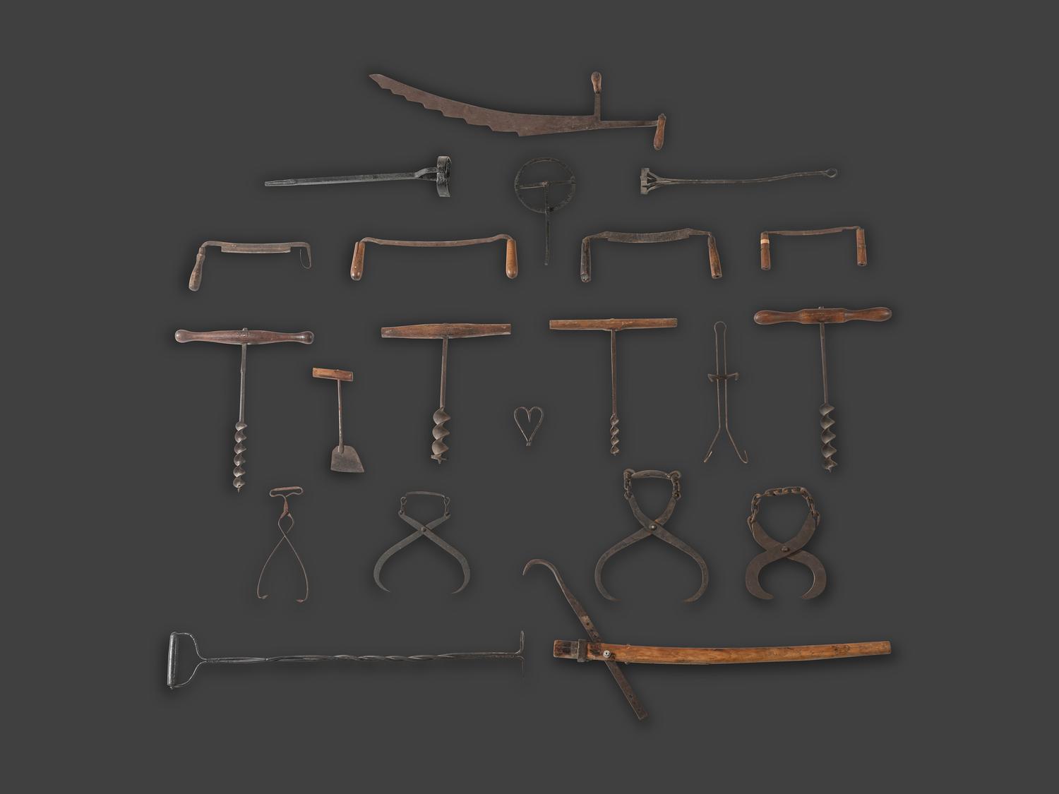A Group of Early Cast Iron and Wood Farm and Carpentry Tools