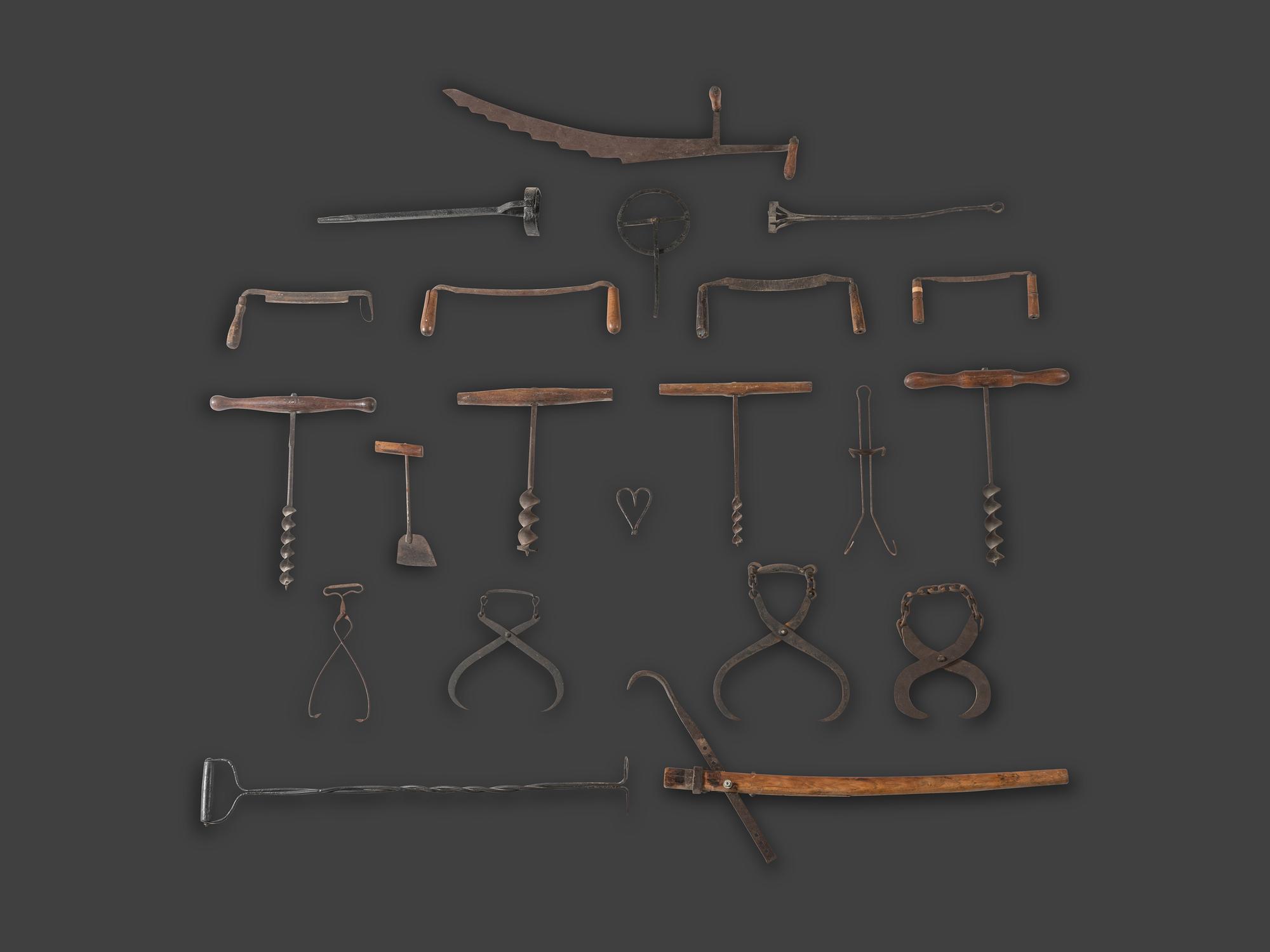 A Group of Early Cast Iron and Wood Farm and Carpentry Tools