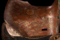 A Gilt and Polychrome Painted Red Lacquer Saddle and Two Pads