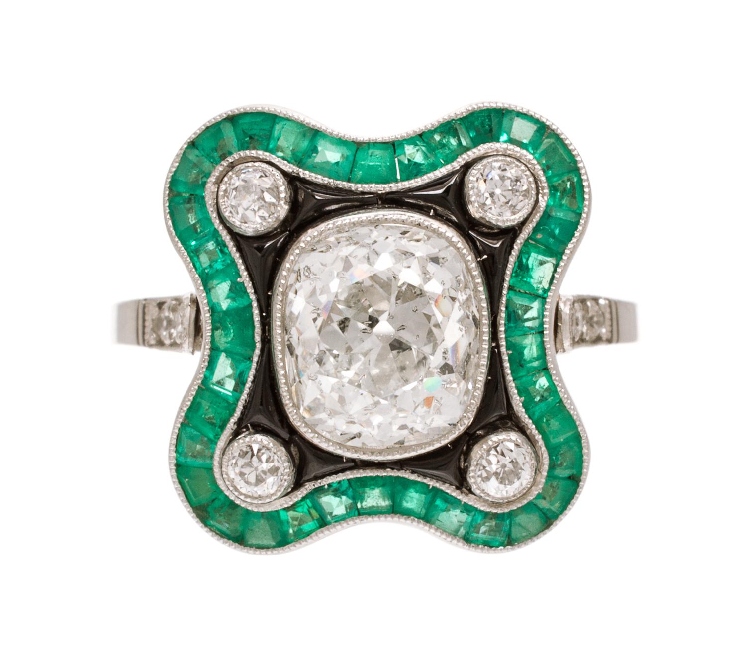 An Art Deco Platinum, Diamond, Emerald and Onyx Ring, 3.90 dwts.
