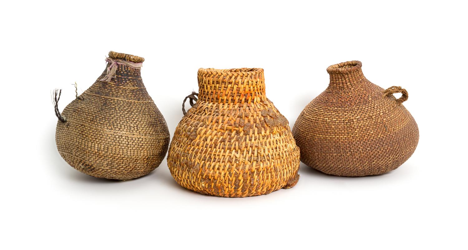 Three Southwestern Bottle Form Baskets Height of tallest 7 inches.