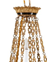 An Empire Style Gilt Bronze and Tole Sixteen-Light Chandelier