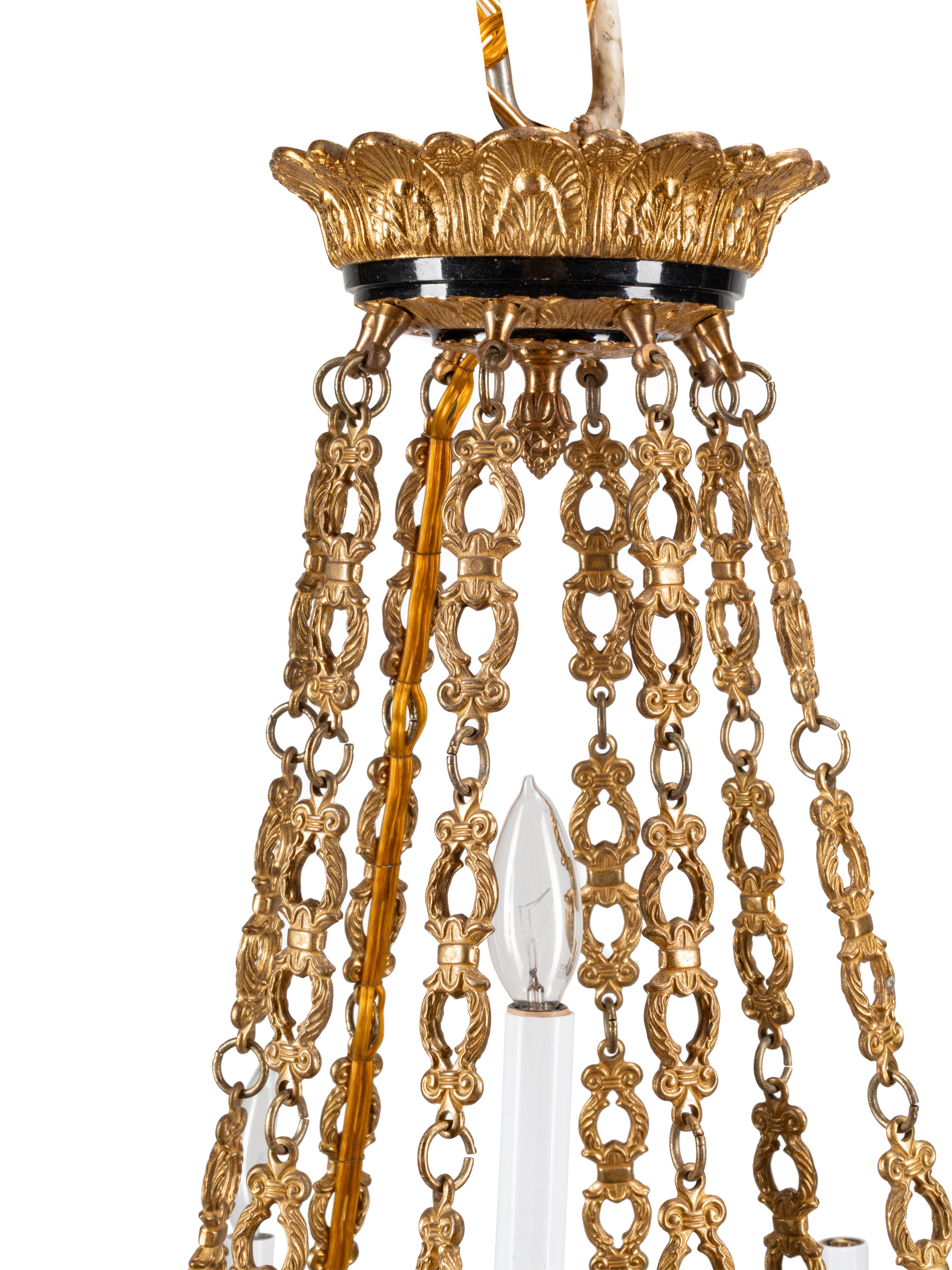 An Empire Style Gilt Bronze and Tole Sixteen-Light Chandelier