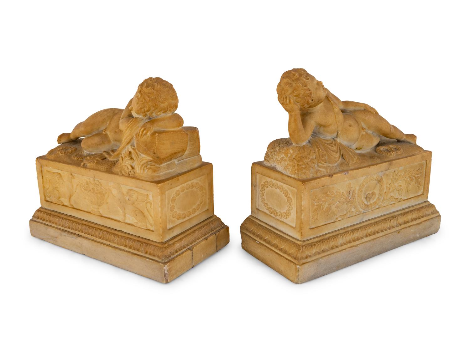 A Pair of Marble Models of Sleeping Cherubs on Plinths